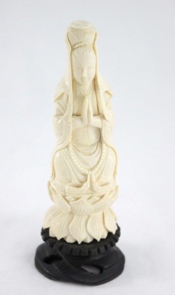 Chinese Carved Ivory Buddha Figure: A Chinese carved ivory figure of a Buddha sitting in a lotus blossom. Carving is on an ebonized wood base. Measurements: 2" x 1.75" x 5.25" Style: 20th Century