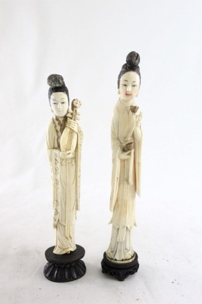 (2) Turn of The Century Ivory Carvings Women: Two turn of the century ivory carvings of women on wooden bases. One is holding cups or goblets and measures 9.5" high, she is marked "China" on the back. The other is holding a pipe and measures 8.75
