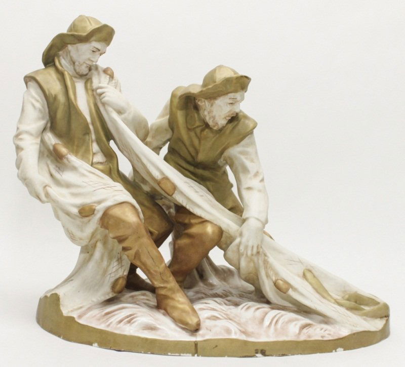 Amphora Fisherman: Amphora figurine depicting two fisherman pulling in their fishing net and catch of the day. Measurements: 17" x 10.25" x 16" Style: Early 20th Century