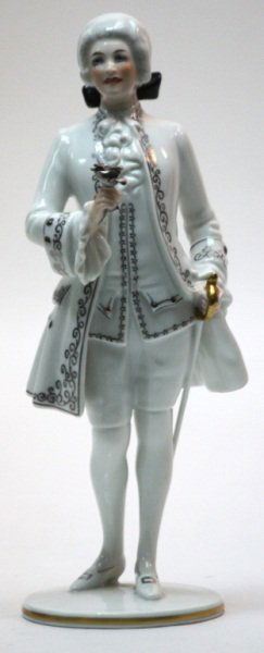 Augarten Wien Porcelain Figure of a Gentleman: Augarten Wien Austrian hand painted porcelain figure with applied gold and silver details of a gentleman with a rose in one hand and sword in the other. Marked on the bottom and numbered 1500. Measure