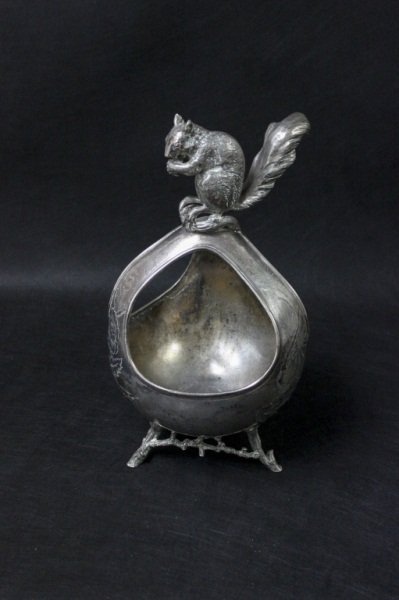 Victorian Silver-plated Squirrel Nut Basket: Victorian Silver plated nut basket with etched markings on basket and ornate squirrel sitting on top. Measurements: 8.5" x 8.5" x 17" Style: Mid-Century