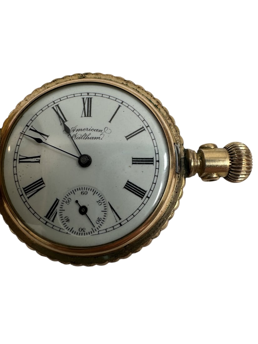 1896 American Waltham Pocket Watch: 1896 rolled gold American Waltham Watch Co pocket watch. Front cover features stars. Inside of front cover blank. White watch face with roman numerals, second hand clock. American Waltham in script at