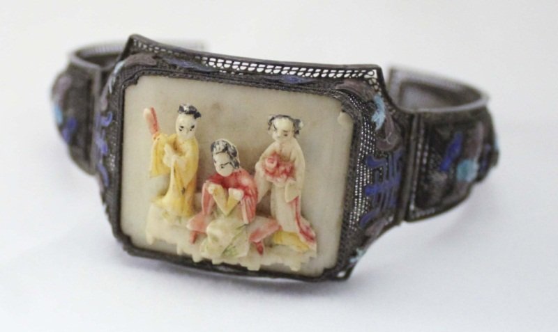 Chinese Silver Filigree, Enamel & Ivory Bracelet: Chinese silver filigree bracelet, the double-hinged form centering an ivory plaque carved in relief with three figures, applied polychrome enamel design of bats and symbols. Bracelet is 8.75" around a