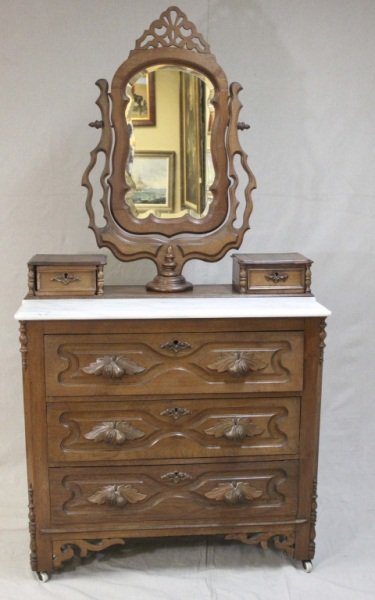 Victorian Marble & Walnut Mirrored Dresser: Victorian marble and walnut mirrored dresser with intricate hand carved detail throughout. Dimensions: 40" x 19.5" x 80.5" Period: 19th Century