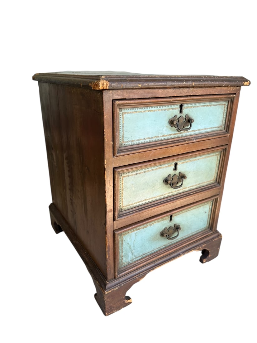 20C Walnut Diminutive Chest of Drawers 3 Drawers: Early 20th Century walnut diminutive chest of drawers with 3 locking drawers (no key), leather top and drawer faces. Marked Made in England. Bracket feet. Tongue and groove drawers. Good condition. Me