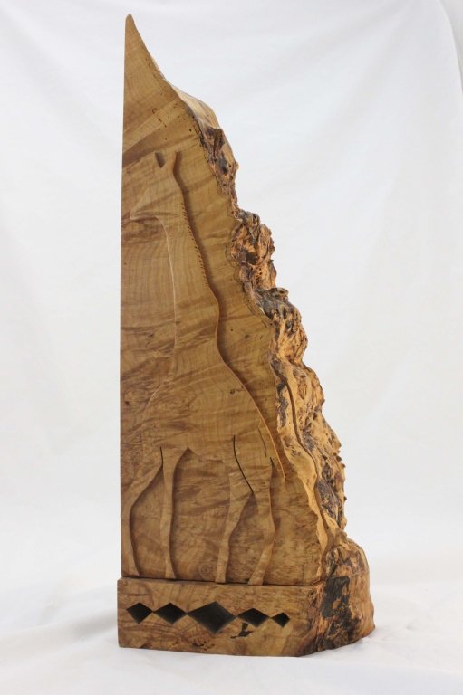 Michael Elkan Burl Wood Giraffe Puzzle Box: Michael Elkan (American b. 1943) carved burl wood puzzle box featuring a large giraffe carved into the front with a smaller box nestled inside. Measurements: 11" x 4.75" x 28.75" Period: 20th Century