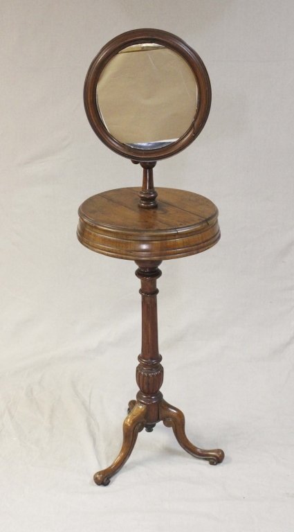 Walnut Barber Shaving Stand with Mirror: Antique walnut barber shaving stand with mirror. Mirror is detachable. Wood is walnut, and there is storage space underneath the mirror. In very good original condition. Measurements: 17" x 56" Period