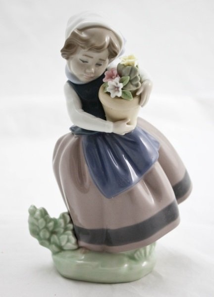 Lladro "Spring Is Here" Figure 01005223: Glazed Lladro "Spring Is Here" Figure 01005223 (Linda Con Maceta) Young girl holding flower pot with scarf. Year Issued: 1984 Not Retired Sculptor: Jose' Puche Stamped on bottom. Measurements: 4.5" x 