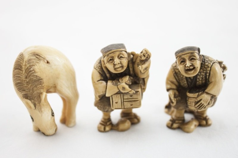Lot of 3 Japanese Ivory Netsuke: Lot of 3 Ivory Netsuke, Two Street Peddlers and a Horse. One with Monkey and Music Box. Two Gift/Storage Boxes. Measurements: All Aprox. 1.75"