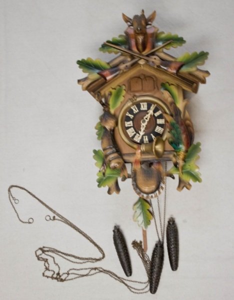 Black Forest Coo Coo Clock: German Black Forest Coo Coo Clock with hand carved details and hunt theme. Minor loss to stag antlers rest of clock is complete and in working condition Measurements: 10" x 6" x 16" Period: Mid centur
