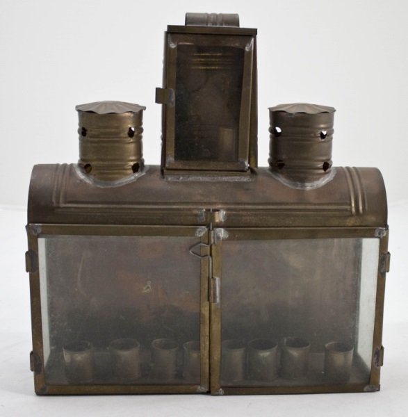 Brass Toll Ware Menorah Made For Out Door Use: Brass Toll Ware Menorah made for outdoor use. Well made and vented so candles stay burning in the wind. Measurements: 13" x 4" x 14" Period: Early 20th Century