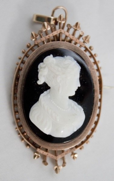 Stone Cameo Brooch/Pendant Set In 14K Rose Gold: Stone cameo brooch / pendant set in 14K rose gold. This hand carved Cameo is of black and white Sardonyx, a natural stone , and referred to as a Hard Stone Cameo. Brooch mounting of 14K Rose Gold, mar