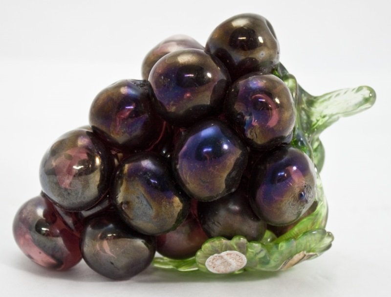 Murano Art Glass Cluster of Purple Grapes: Murano cluster of dark purple hand blown glass grapes. Original Murano label is still intact. Has formed green glass leaf with curly vine and stem. Dimensions: 7" x 4" x 5" Period: 1930's Artist: Mura