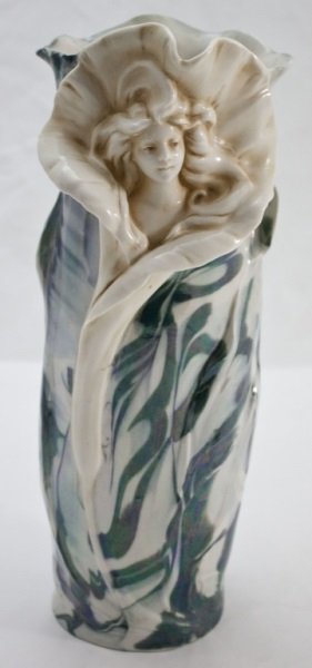 Royal Dux Porcelain Vase w/ Woman / Flower: Royal Dux bohemia porcelain vase. Art Nouveau style with woman's bust emerging from unfolding flower. Marked on base, "5151" and "7" with pink triangle. Dimensions: 5" dia x 14" tall Period: 19th Cent