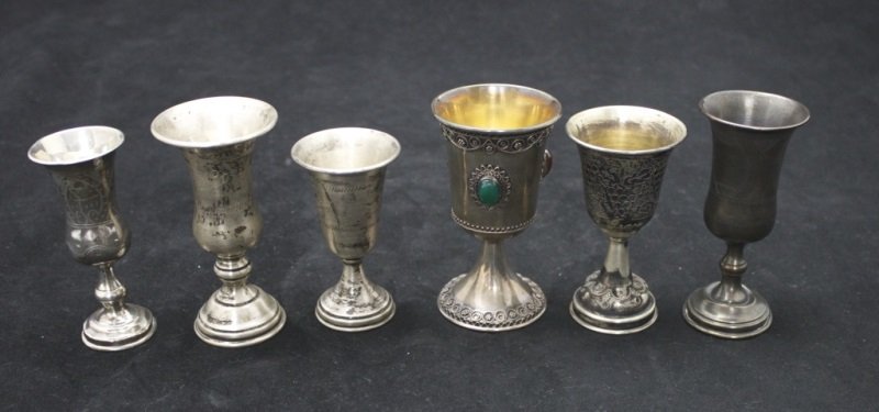Collection Of 6 Sterling Silver Kiddush Cups: Lot of 6 sterling silver Kiddush cups, lot includes: Ornate cup with inlaid stones and applied decorations, marked ZADOK 925 Israel- measures 2.30" dia x 4" tall. Bright cut and engraved cup, marked w