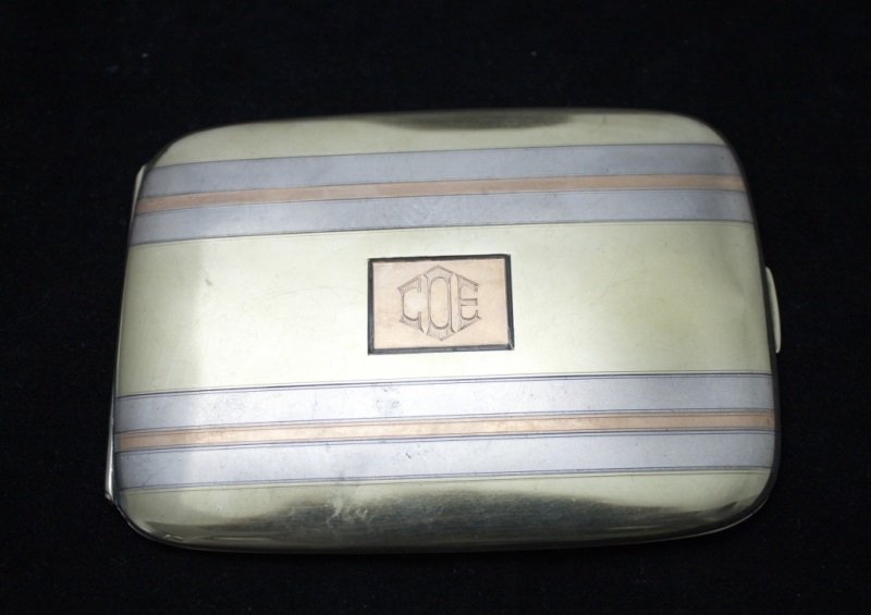 14k Gold & Sterling Silver Cigarette Case: 14k Gold and sterling silver cigarette case. Engraved on front "COE" and inside "C.E. Otter Detroit" Marked 14k & Sterling with Assayers marks. Dimensions: 4.5" x 3.5" Period: 1940's Artist: 4.50 ozt.