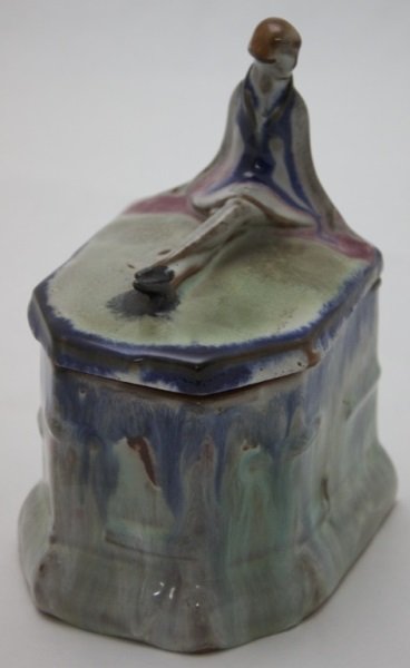 Art Deco Figural Dresser Jar Ramses Earthenware: Art Deco dresser Jar in the form of a flapper girl seated on a pier. Mfg by Ramses, drippy tin glaze over earthenware. 3.75" x 3.75" x 5.75" 1920's