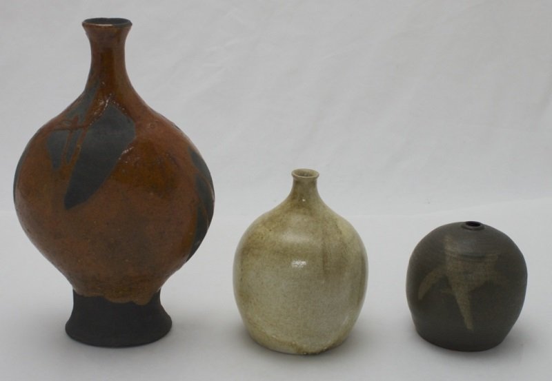 3 Earth & Ware Pottery Vases: 3 Earth and ware pottery vases, lot includes; Retro stoneware pottery. Gourd shaped, matte black, with a deep orange lava glaze with abstract shapes left unfinished. Very unique, signed E S Jensen. Me