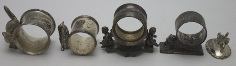 4 Figural Quadruple Plate Napkin Rings Card Holder: 4 Quadruple plate figural napkin rings with one place card holder. Largest ring with cherubs measures 3.5" 2" x 2.5" Smallest ring with owl measures 2.25" x 1.9" x 1.75" Place card holder is 2" x 1.5"