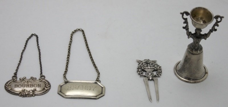 Sterling Silver Jigger, Bottle Tags & Fork: Sterling silver jigger, bottle tags and fork, lot includes; Sterling Art Nouveau jigger, marked Reed & Barton Sterling x22. Measures 3.05" x 1.5". Sterling silver bottle tag- engraved "BRANDY"- chain 