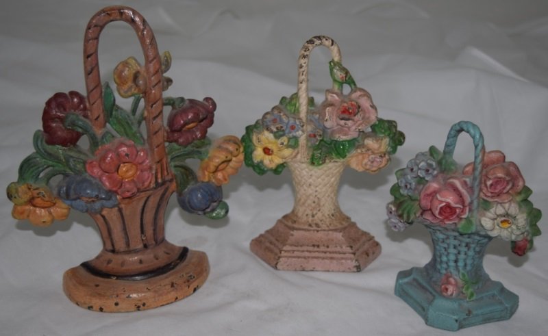 3 Antique Cast Iron Floral Painted Doorstops: 3 Antique cast iron floral hand painted doorstops. Large doorstop is 7" x 2" x 8.5" , smallest door stop is 4.5" x 2" x 5.5" medium doorstop is 5" x 2" x 7". All with original paint. 19/20th century