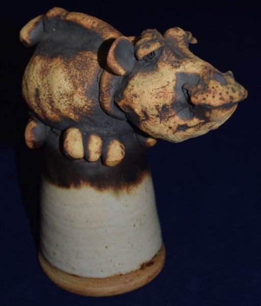 Todd Warner Ceramic Hippo Sculpture/ Dinner Bell: Todd Warner Ceramic Hippo Sculpture/ Dinner Bell. Smiling Hippopotamus sits on top of bell. Signed "Todd Warner '74" on inside of bell. 8" x 7"