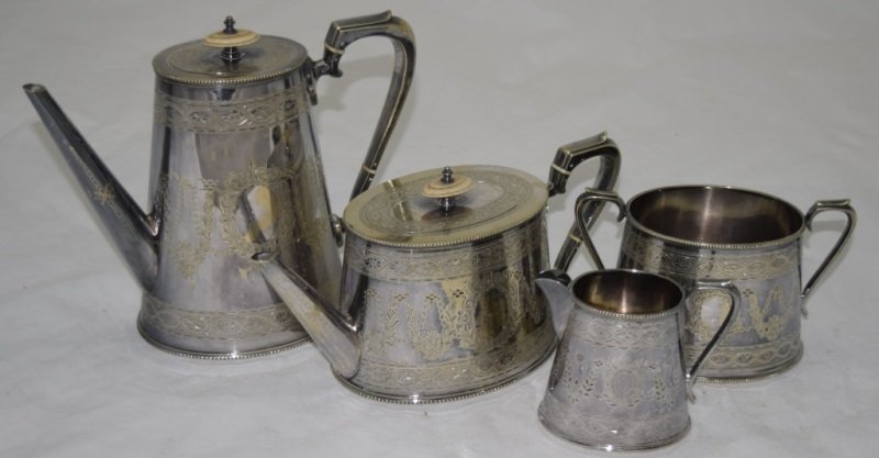 19C Edwardian Sheffield Silver Coffee Tea Service: 19C Edwardian Sheffield Silver coffee and tea service with a lidded tea pot sugar bowl and creamer. Ivory details to lids and thermal breaks on handles. Tea pot measures 10" x 4.75" x 5" Coffee pot me