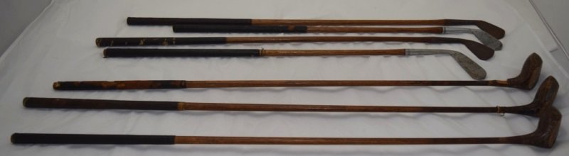 7 1920's Golf Clubs Wooden Shaft Irons & Woodies: 7 1920's Wooden shaft irons and woodies golf clubs. Two clubs are dimple faced iron and two are stainless steel and lined. There are three woodies. one solid and two ivory face. All wooden shaft clubs