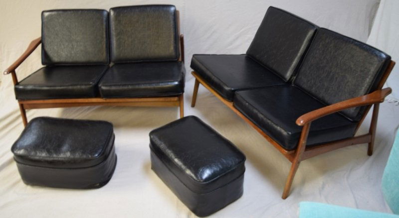 Pair of Settees with Matching Leather Ottomans: 2 Mid century modern matching teak settees with black leather cushions and matching black leather ottomans. Ottomans measure 21" x 14" x 11" 46" x 30" x 27" 1950s