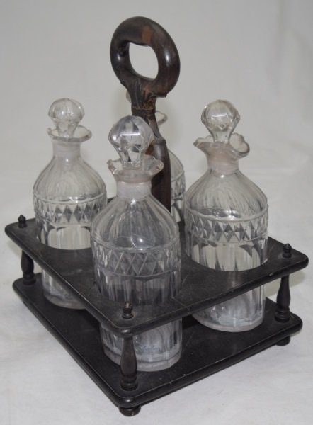 Victorian Cut Crystal Decanter Set w Ebonized Wood: Victorian cut crystal four decanter set with ebonized wood carrier. Residue in bottom of decanters. See photos. 9.5" x 12" Victorian