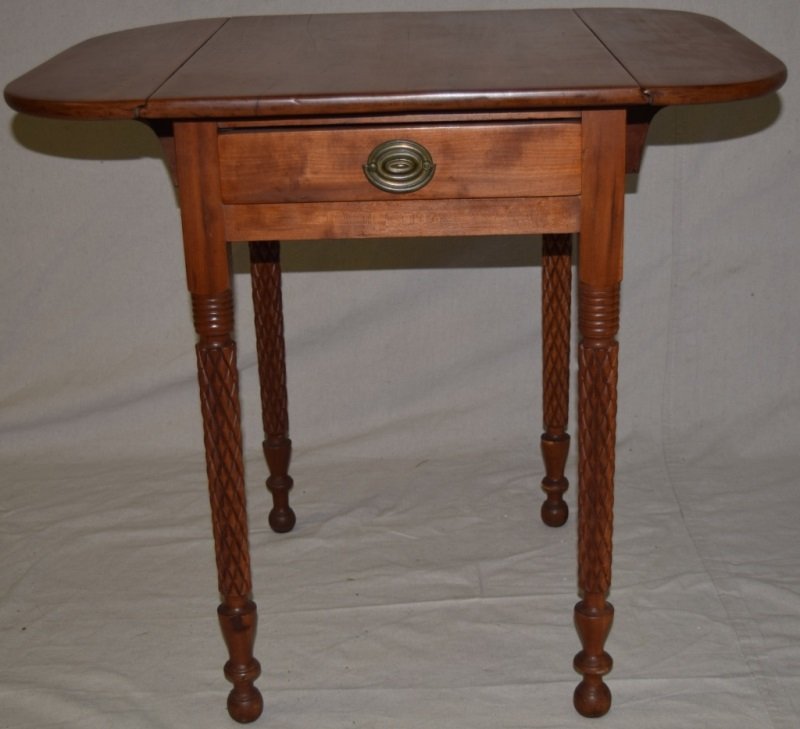 Sheridan Maple Single Drawer Drop Leaf Table: Sheridan maple single drawer drop leaf table with knurled legs. Measures 31.5" wide with both leaves open and 19" with them down. Hand cut dovetail drawer 31.5 open x 26" x 28.5