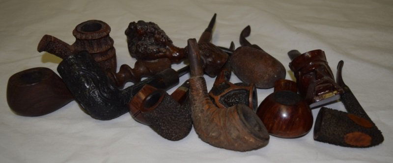 10 Burl Briar Wood Estate Various Pipes: Lot includes; Viking figural carved pipe, unmarked, unused. 5.5" L. Spiral wooden pipe, unmarked, unused. 7" L. The favourite 9495 Briar Genuine Briar, used. 6" L. Jobey 115 Intaglio Filter, used. 6"