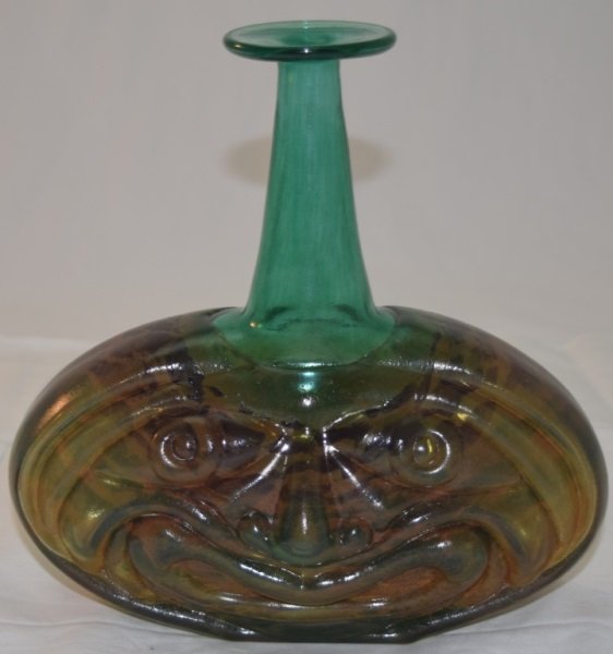 Kosta Boda Face Vase signed Kjell Engman: Kosta Boda vase, by Kjell Engman, signed to under side. Large molded face with yellow, blue, green and purple mottled glass and an applied neck. 9" x 3.5" x 9"
