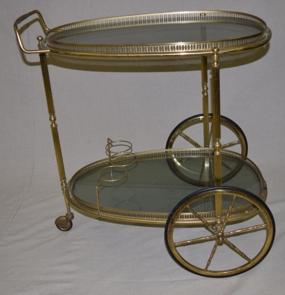 1950's Italian Brass & Glass Serving Cart: 1950's Italian brass and glass oval form spoke wheeled serving cart.. 22" x 30" x 31"