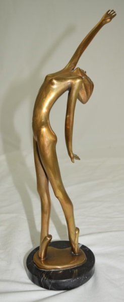 Tom Bennett Bronze Sculpture Nude Woman: Tom Bennett signed, dated 1983 and numbered 51/500 bronze sculpture of a nude woman reaching for the sky. 4" x 5" x 14.5" 1983
