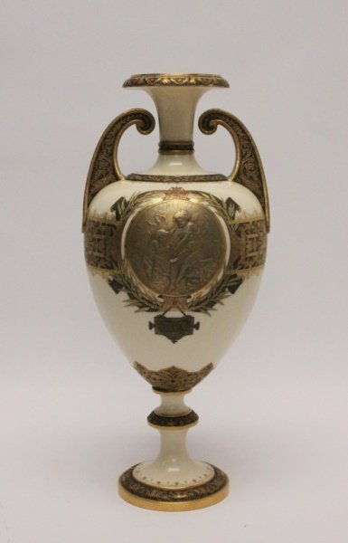 19th C Royal Worcester Grecian Urn Form Vase: 19th century Royal Worcester Grecian urn form vase. Cream colored porcelain with heavily embossed gold gilt details. Center image on one side depicts a girl and a cherub with a plaque beneath, "POETRY