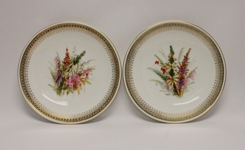 (2)1875 Royal Worcester Hand Painted Plates: (2) 1875 Royal Worcester gold gilt porcelain dessert plates, hand painted with ornate hollyhock bouquets and jeweled borders. Stamped and numbered on bottom. Excellent condition. Measure 9"dia, each.