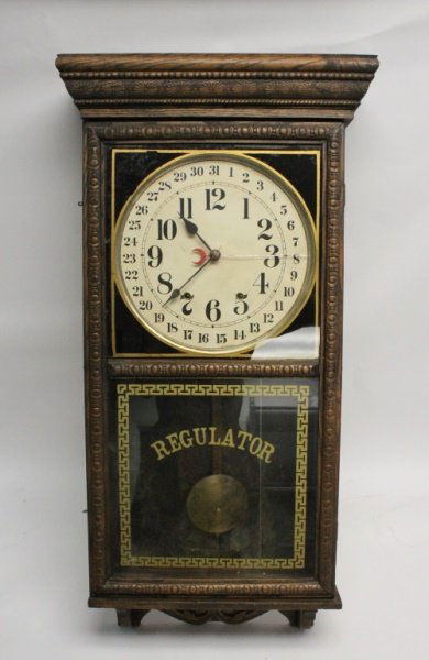 19th C Carved Wood Regulator 31 Day Wall Clock: 19th century Regulator 31-day wall clock with carved wood case. Excellent working condition. Measures 18.5" x 6" x 37".