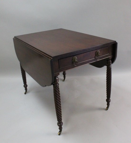 1920's Charleston, SC Mahogany Pembroke Table: Circa 1920 mahogany single drawer drop leaf table or Pembroke table with finely carved, turned legs and brass wheels. Made in Charleston, South Carolina. Excellent condition. Measures 38" x 50" x 29".