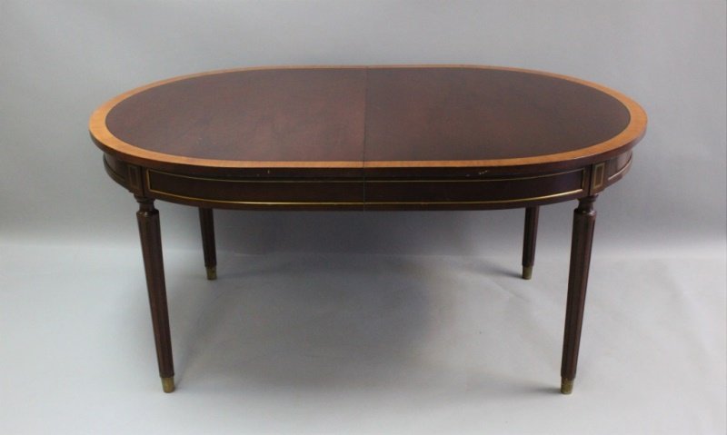Banded Mahogany and Brass Inlay Dining Table: Federal style, banded mahogany and brass inlay dining table with turned, fluted, brass-footed legs. Very good condition, shows signs of wear (see photos). Measures 62" x 42" x 30" and includes two 18"