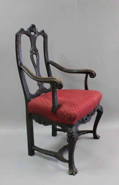 17th / 18th C Carved Shell Motif Wooden Arm Chair: Late 17th or early 18th century carved wooden arm chair with floral and seashell motif. Unique carved stretcher and trifid feet. Excellent condition. Measures 25" x 20" x 38".