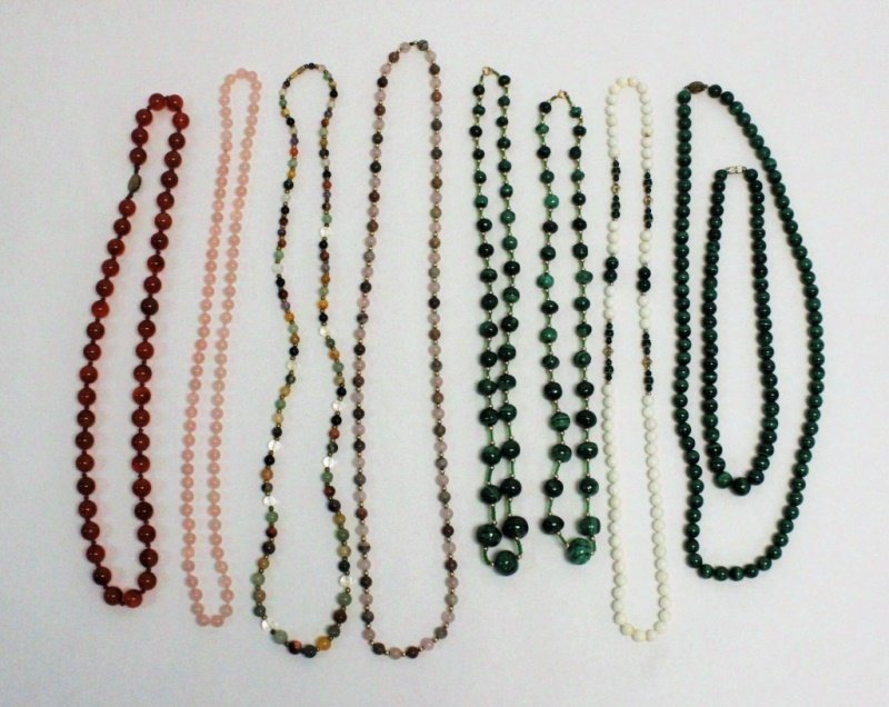 (9) Mixed Gemstone Necklaces w Silver, Gold Clasps: (9) Strands of polished round gemstone necklaces, some with sterling silver or gold filled clasps. The gemstones include malachite, rose quartz, carnelian, amethyst, white agate, laboradite, smoky qua