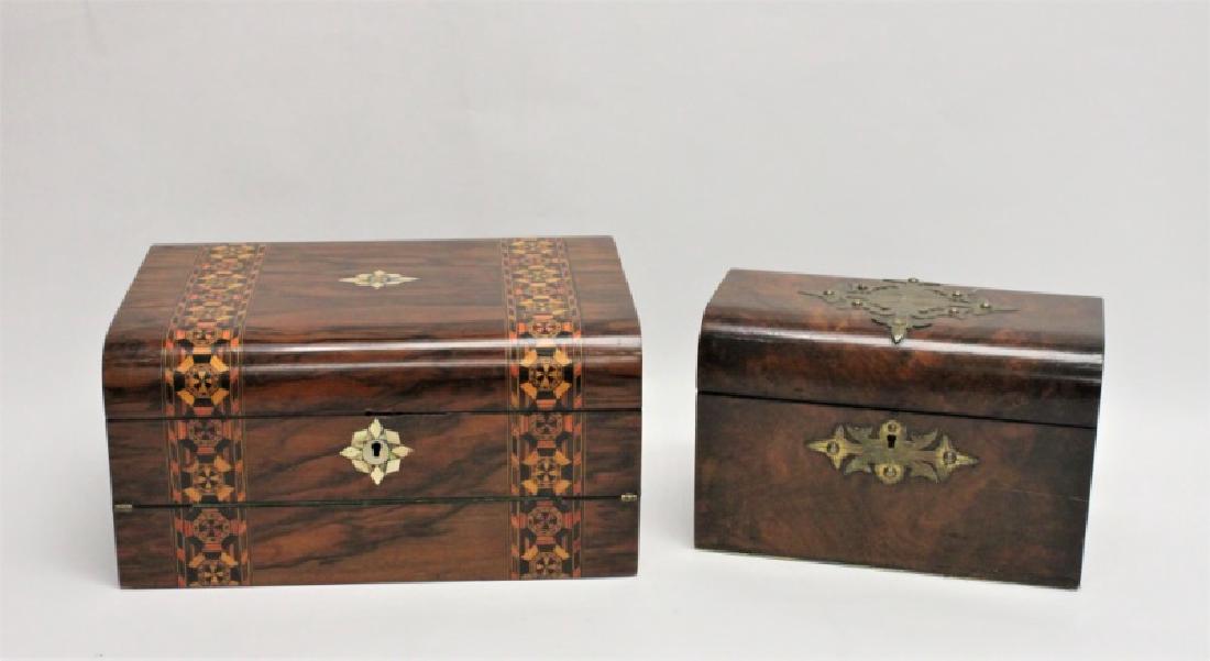 (2) 19C Boxes Tea Caddy & Traveling Desk: (2) Antique 19th Century decorative boxes: (1) Burl and brass bound tea caddy. Very good condition. Measures 9" x 5" x 6". (1) Traveling desk inlaid with exotic woods. Good condition (hinges need repa