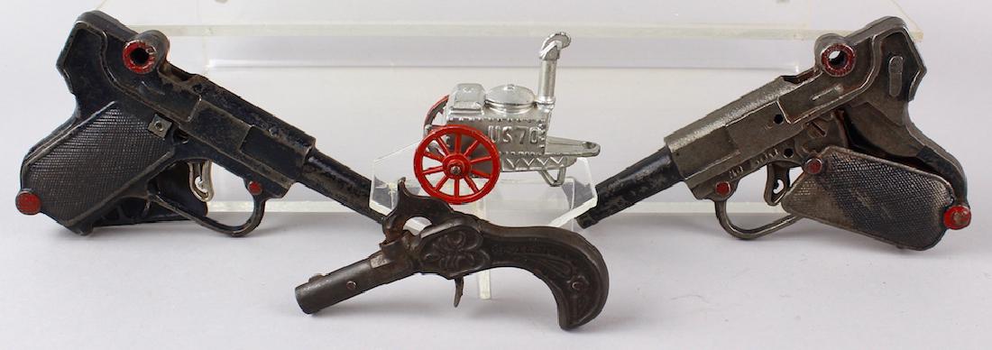 Stevens & Cast Iron Cap Gun Lot w Barclay: Stevens early cast iron single shot cap gun & pair of Cast Iron Luger Cap Guns. Barclay slush military cart with lot.