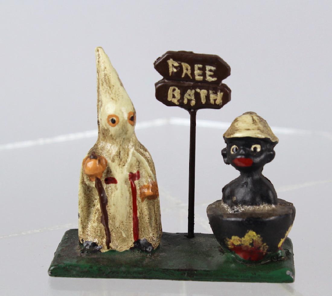 Racist KKK Clan Figure & Native in Cooking Pot: Cast iron "Free Bath" figural toy of Clansman with African in pot. Measures 5 inches wide.