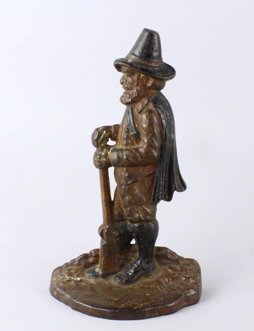 Bradley & Hubbard Pilgrim with Musket Door Stop: Bradley & Hubbard Pilgrim with Musket Door Stop. Miles Standish type figure with gun heavy cast iron door stop. 10 1/4"tall. Original paint.