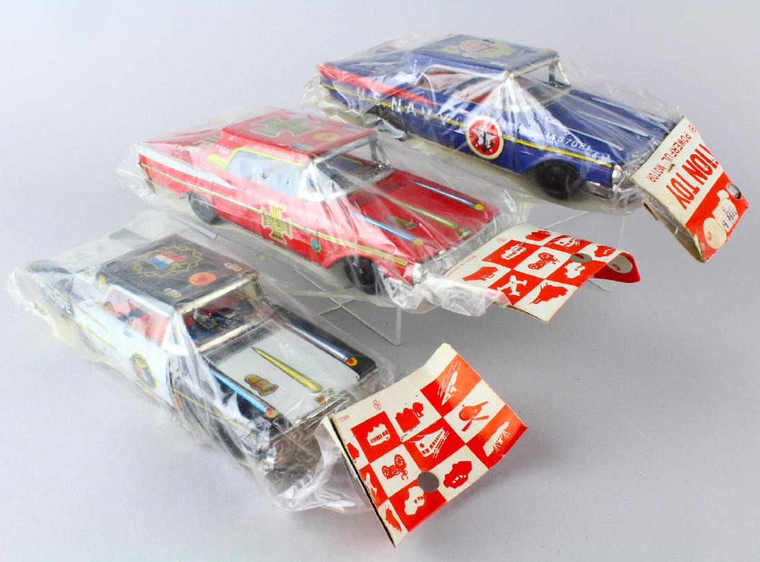 3 Japan Tin Friction Cars Mint in Package: japan Tin Friction Cars Mint in Package- Fire Police and Navy larger format tin cars never opened old store stock. Cars 8 inches long.