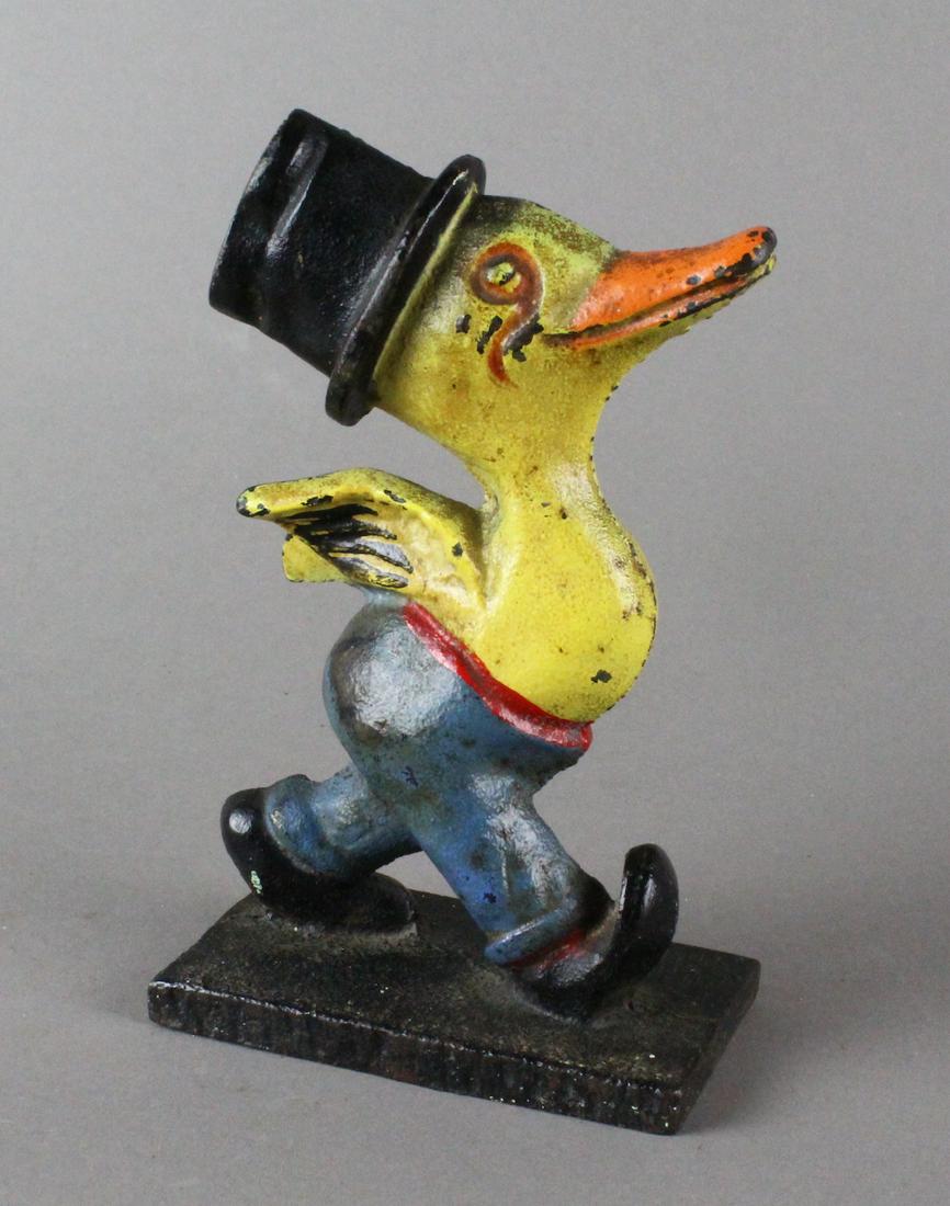 Duck with Top Hat & Monocle Doorstop: Cast Iron Duck with Top Hat & Monocle. Excellent condition, bright original paint. Duck strolls proudly with wings held high 5 3/4 inches tall.