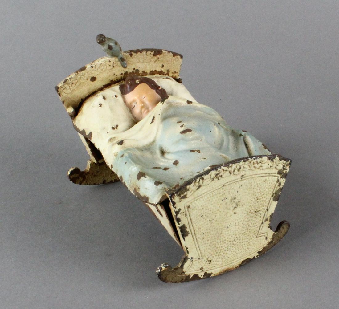Baby in Cradle with Blue Bird Still Bank: Baby in Cradle with Blue Bird Still Bank. Metal 4 inches long.