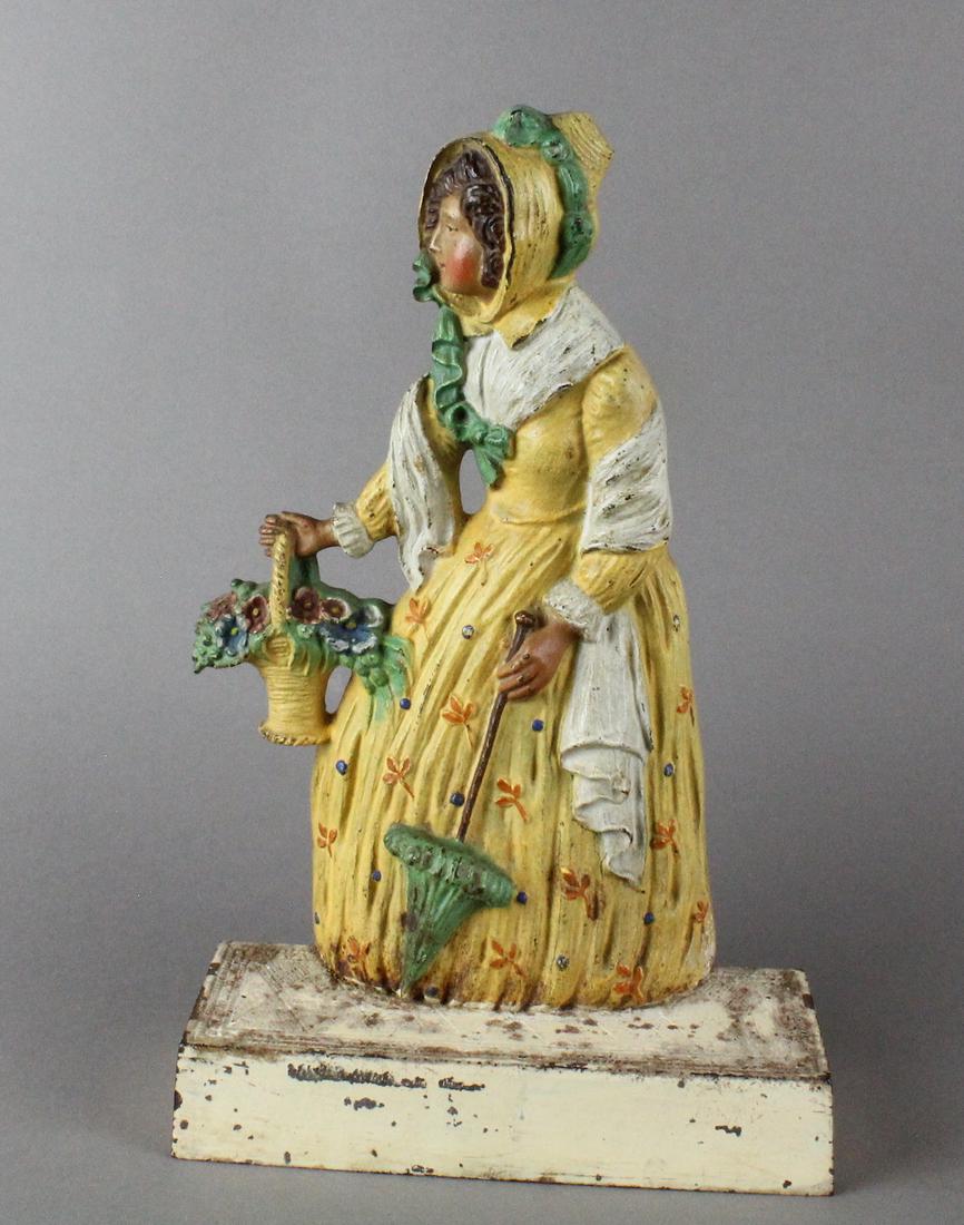Bradley & Hubbard Woman w/Parasol Doorstop: Bradley & Hubbard Woman w/Parasol Doorstop #7796, features lady in yellow ruffled dressed, flower basket and parasol. Crisp detail and excellent original paint.